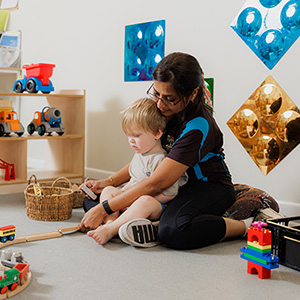 Teacher with young child at day care
